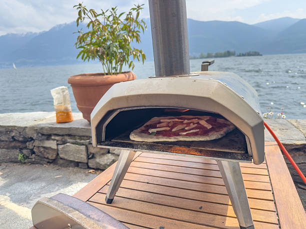 istock Outdoor Pizza Oven by Lake with Uncooked Pizza 2209893163