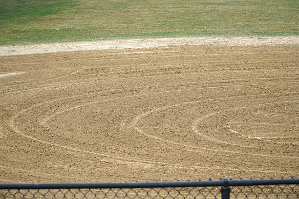 The second base on a softball field highlights a suburban Tokyo team practicing together.