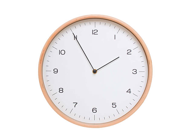istock Minimal wall clock with light wood frame and white face displaying 01:55 or 13:55. Perfect for clean, modern concepts about time and scheduling. 2209902381