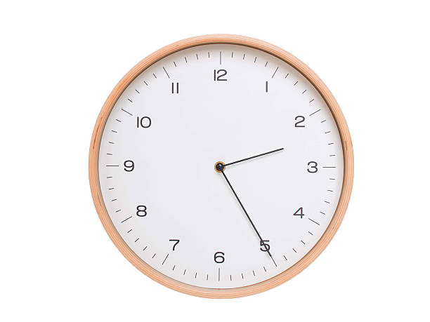 Minimal wall clock with light wood frame and white face displaying 02:25 or 14:25. Perfect for clean, modern concepts about time and scheduling.