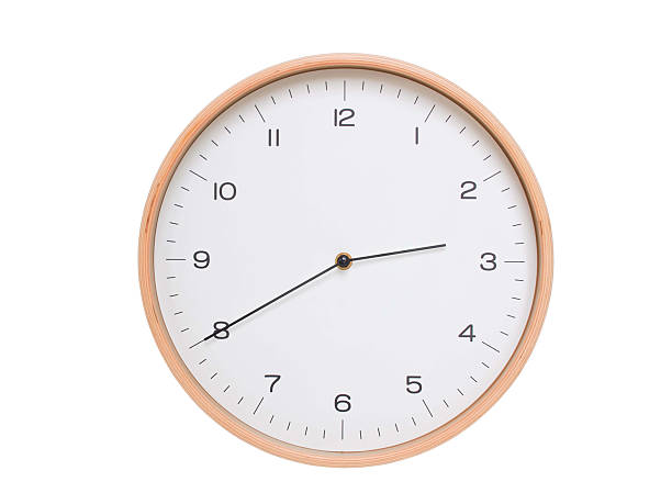 Minimal wall clock with light wood frame and white face displaying 02:40 or 14:40. Perfect for clean, modern concepts about time and scheduling.