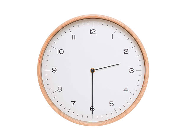 Minimal wall clock with light wood frame and white face displaying 02:30 or 14:30. Perfect for clean, modern concepts about time and scheduling.