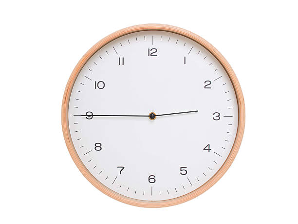 Minimal wall clock with light wood frame and white face displaying 02:45 or 14:45. Perfect for clean, modern concepts about time and scheduling.