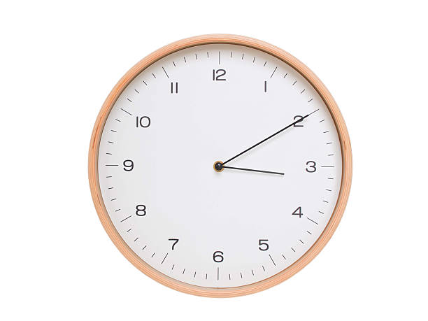 istock Minimal wall clock with light wood frame and white face displaying 03:10 or 15:10. Perfect for clean, modern concepts about time and scheduling. 2209902446