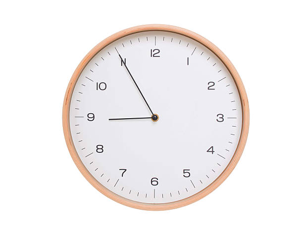 istock Minimal wall clock with light wood frame and white face displaying 08:55 or 20:55. Perfect for clean, modern concepts about time and scheduling. 2209903066
