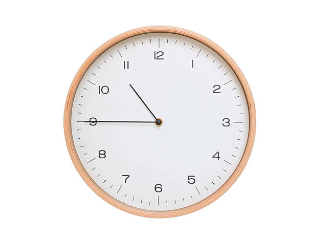 istock Minimal wall clock with light wood frame and white face displaying 10:45 or 22:45. Perfect for clean, modern concepts about time and scheduling. 2209903161