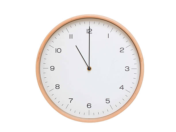 istock Minimal wall clock with light wood frame and white face displaying 11:00 or 23:00. Perfect for clean, modern concepts about time and scheduling. 2209903172