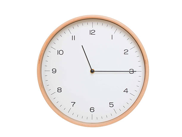 istock Minimal wall clock with light wood frame and white face displaying 11:15 or 23:15. Perfect for clean, modern concepts about time and scheduling. 2209903190