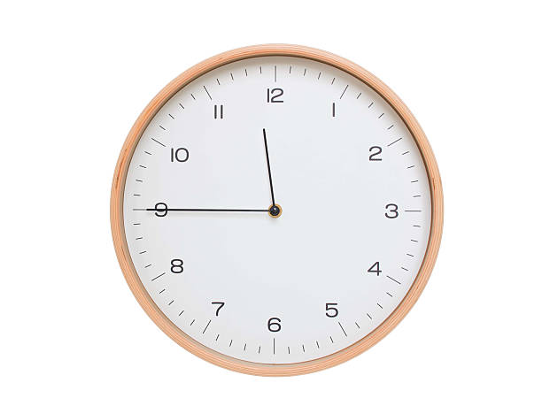 istock Minimal wall clock with light wood frame and white face displaying 11:45 or 23:45. Perfect for clean, modern concepts about time and scheduling. 2209903217