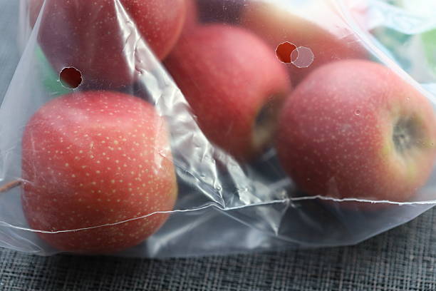 istock A bag of apples sitting on a wooden table 2209909303