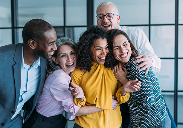 istock Excited coworkers embracing each other during a celebration in the office. 2209911776