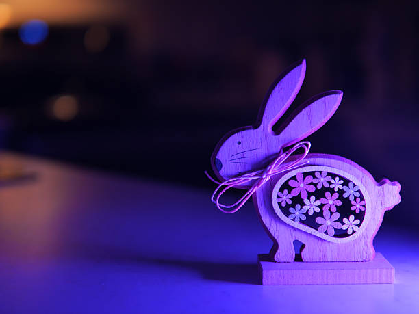Bunny rabbit ears made of natural plants material on pastel purple background. Easter minimal concept. Flat lay.