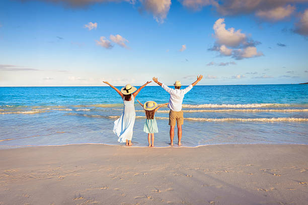 istock A happy family on vacations stands on a tropical beach 2209917731