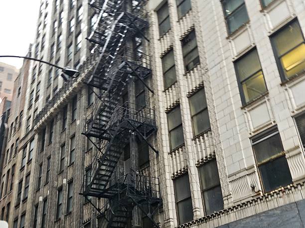 Architectural detail of colorful historic buildings in New York City featuring fire escapes and ornate designs, capturing the urban charm and classic style of the area.