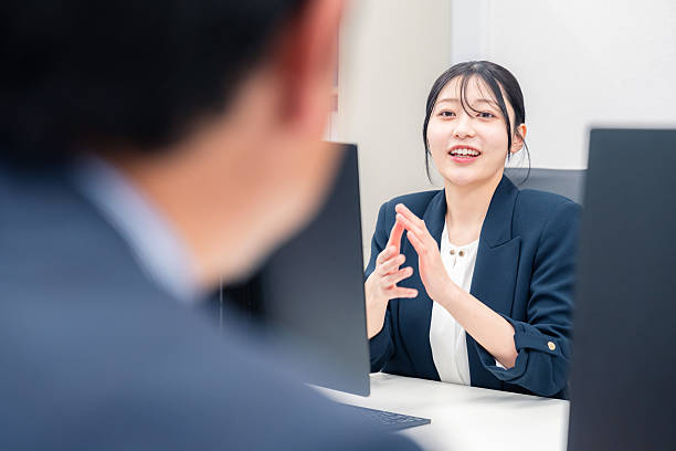 istock A young woman working at a desk in an office with a lively 2209920162