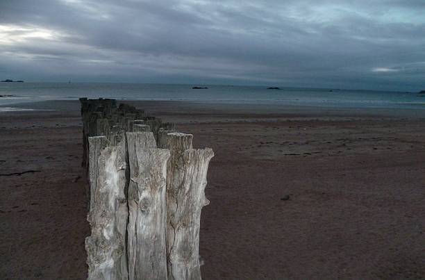 Wooden posts on the beach in Saint-Malo-France in the night light