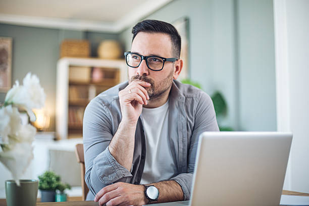 istock Thoughtful man in front of laptop 2209922543
