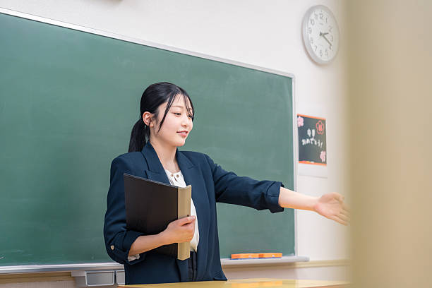 Happy African American female teacher giving a lesson on a class at elementary school.