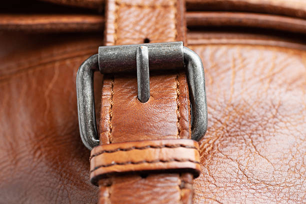 Clasp on brown leather bag. Close-up.