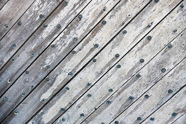 Background of gray textured wooden boards with nails.