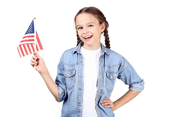 istock Young girl holding an American flag on white background 2209934953