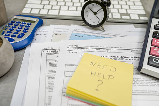 istock Text Need help on sticker Annual tax polish tax forms PIT-36 PIT-37 PIT-38 with pen calculator. 2209935952