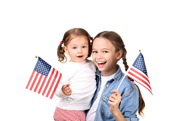 istock Two sisters with American flag on white background 2209935970