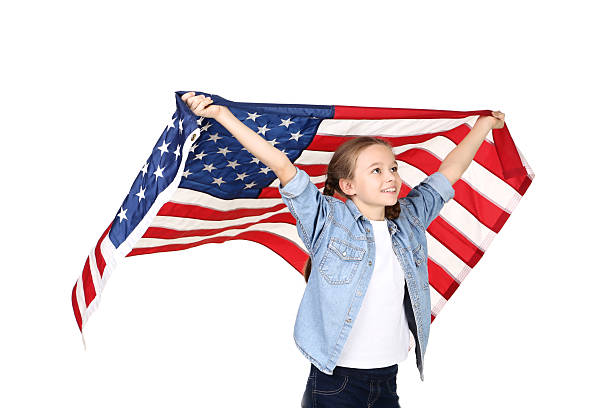 istock Young girl holding an American flag on white background 2209936131