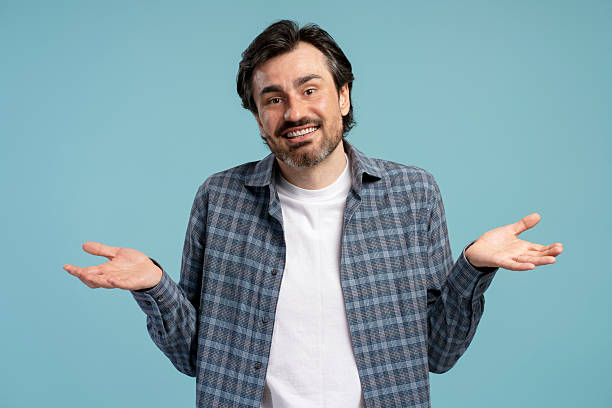 istock Confused man shrugging shoulders gesturing i don't know 2209937613