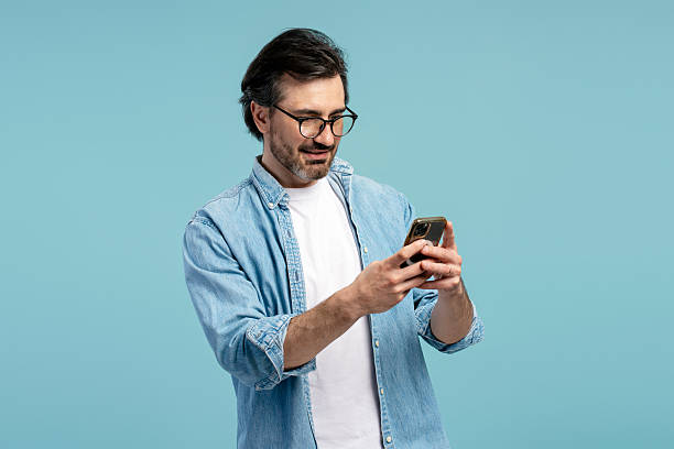 istock Casual businessman using mobile phone, browsing internet, chatting online, ordering, shopping, blue background 2209937630