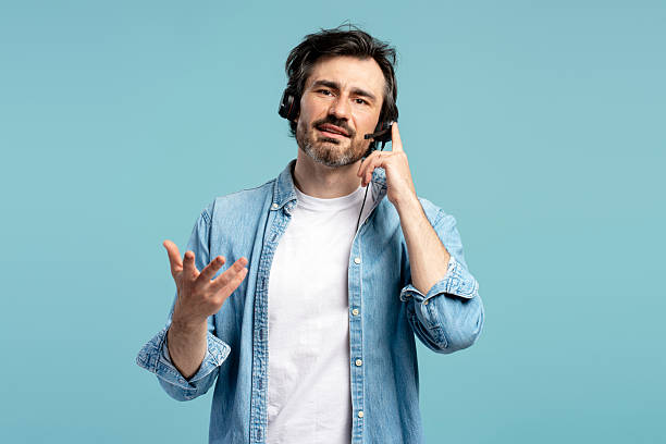 istock Call center operator wearing headset is having a conversation on blue background 2209937659