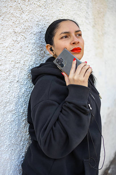 istock A woman enjoying music, lost in thought, blending modern tech with personal expression. 2209940515