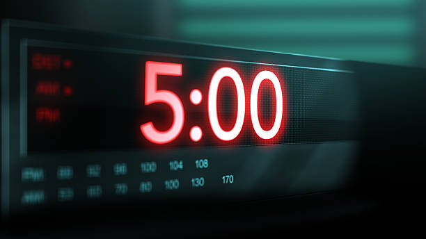 istock Camera pans across old digital clock as time arrives at 5 AM 2209947769