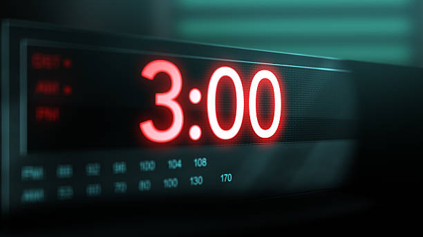 istock Camera pans across old digital clock as time arrives at 3 AM_ 2209947777