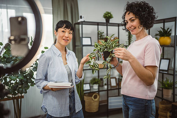 istock two woman use mobile phone for live stream about care home plants 2209949201