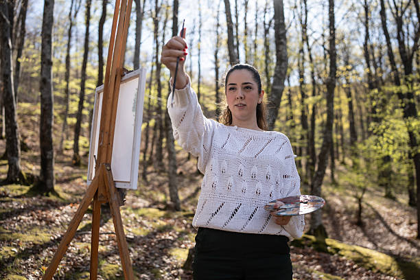 istock Artist Painting on Canvas in a Forest During Springtime 2209951045