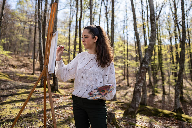 istock Artist Creating a Painting in a Serene Forest Setting in Springtime 2209951094