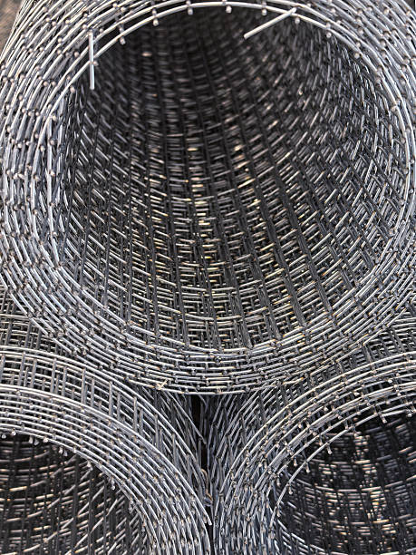 istock Metal wire mesh rolls stacked neatly in a warehouse setting 2209960847
