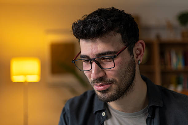istock Portrait of a young man working from home at night looking down 2209960980