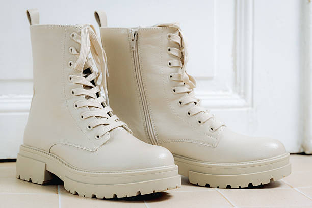 istock Beige boots on the tiled floor by the door. 2209963064