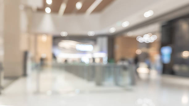 istock Blurred office building lobby or hotel blur background interior view toward reception hall, modern luxury lounge, white room space with blurry corridor and building glass wall 2209969364