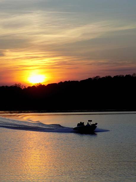 istock Boat on the Lake at Sunset 2209973676