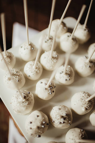 istock White vanilla cake pops with silver sprinkles decoration at wedding reception 2209974440