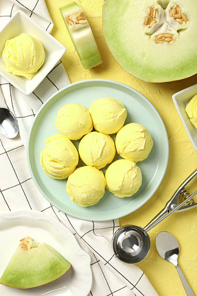 istock Ice cream scoops in a bowl with slices of fresh melon 2209978534