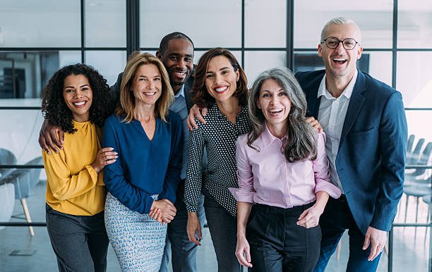 istock Excited coworkers embracing each other during a celebration in the office. 2209979729