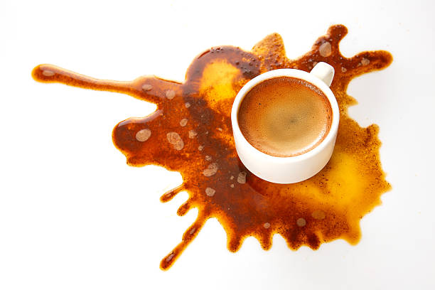 istock Dark espresso spills from a white cup, forming an abstract brown stain on a clean background, highlighting the beauty in everyday messes 2209987135