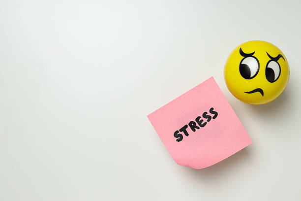 Paper with the word Stress and ball on white background, space for text