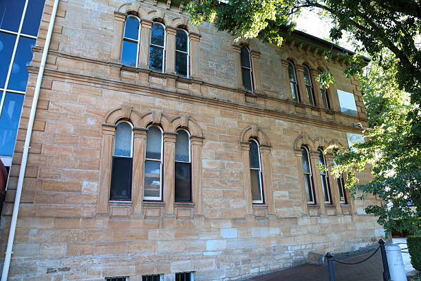 windows in an old building filled in by traditional bricks giving a wall with interesting features