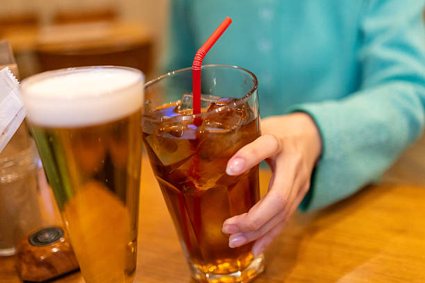 istock Young woman toasting with alcohol in cafe 2209991347