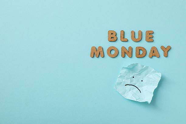 istock Blue Monday text and paper with sad emoji on blue background, space for text 2209992630